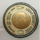 An Edward VII half sovereign, St George on the obverse 1904, in a vintage Tabasco Sauce badge