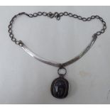 A silver coloured metal multi-link chain necklet, set with a black stone