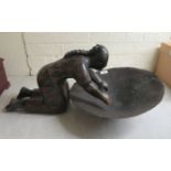 A studio pottery figure, kneeling beside a bowl  16"h