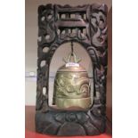 A 20thC Chinese cast bronze table bell, in a carved hardwood frame  12"h  8"w