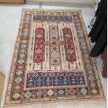 A Caucasian rug, decorated with repeating stylised designs, on a multi-coloured ground  58" x 88"