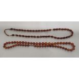 Two amber coloured oval and round bead necklaces