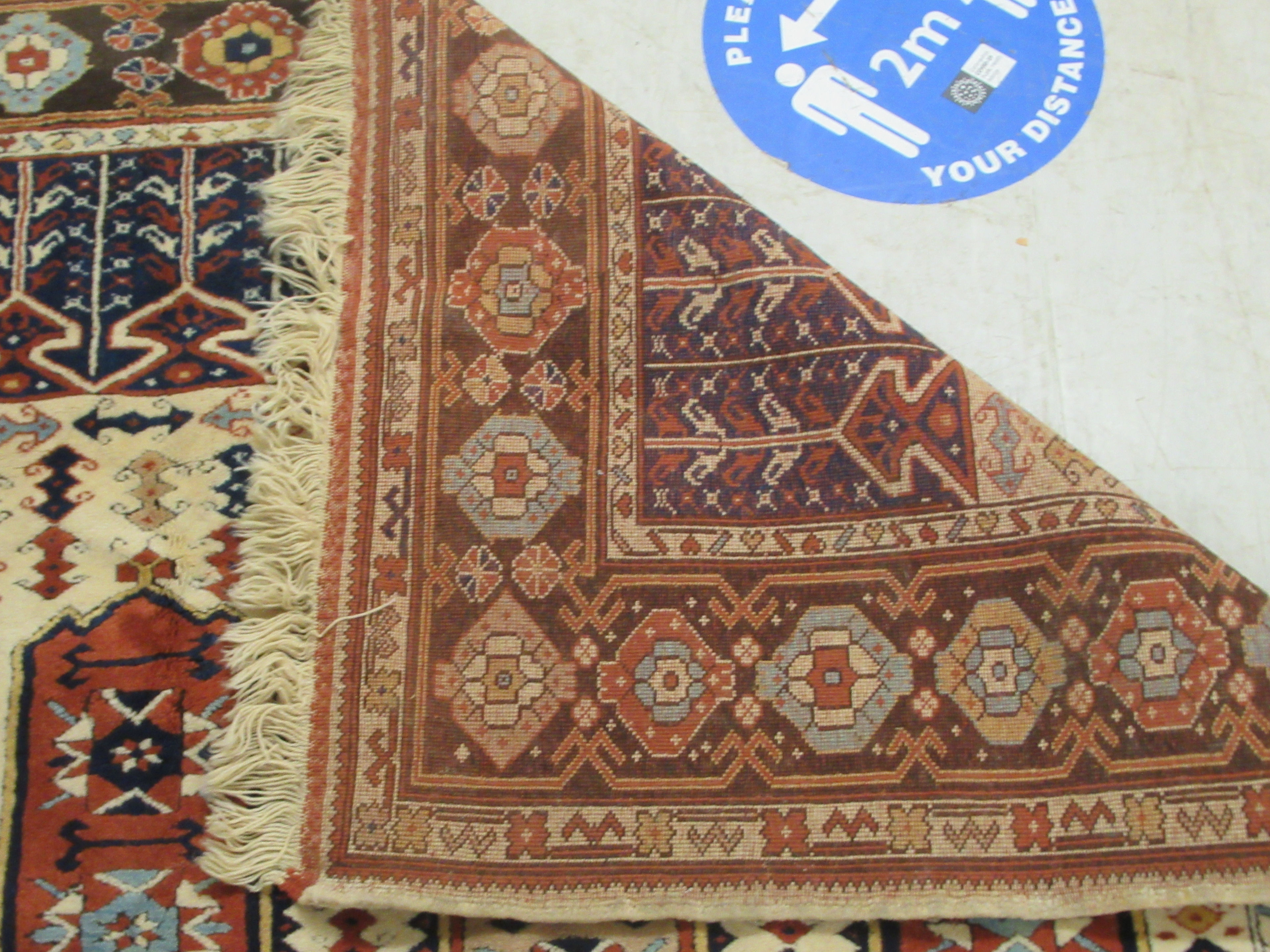 A Caucasian rug, decorated with repeating stylised designs, on a multi-coloured ground  58" x 88" - Image 5 of 5