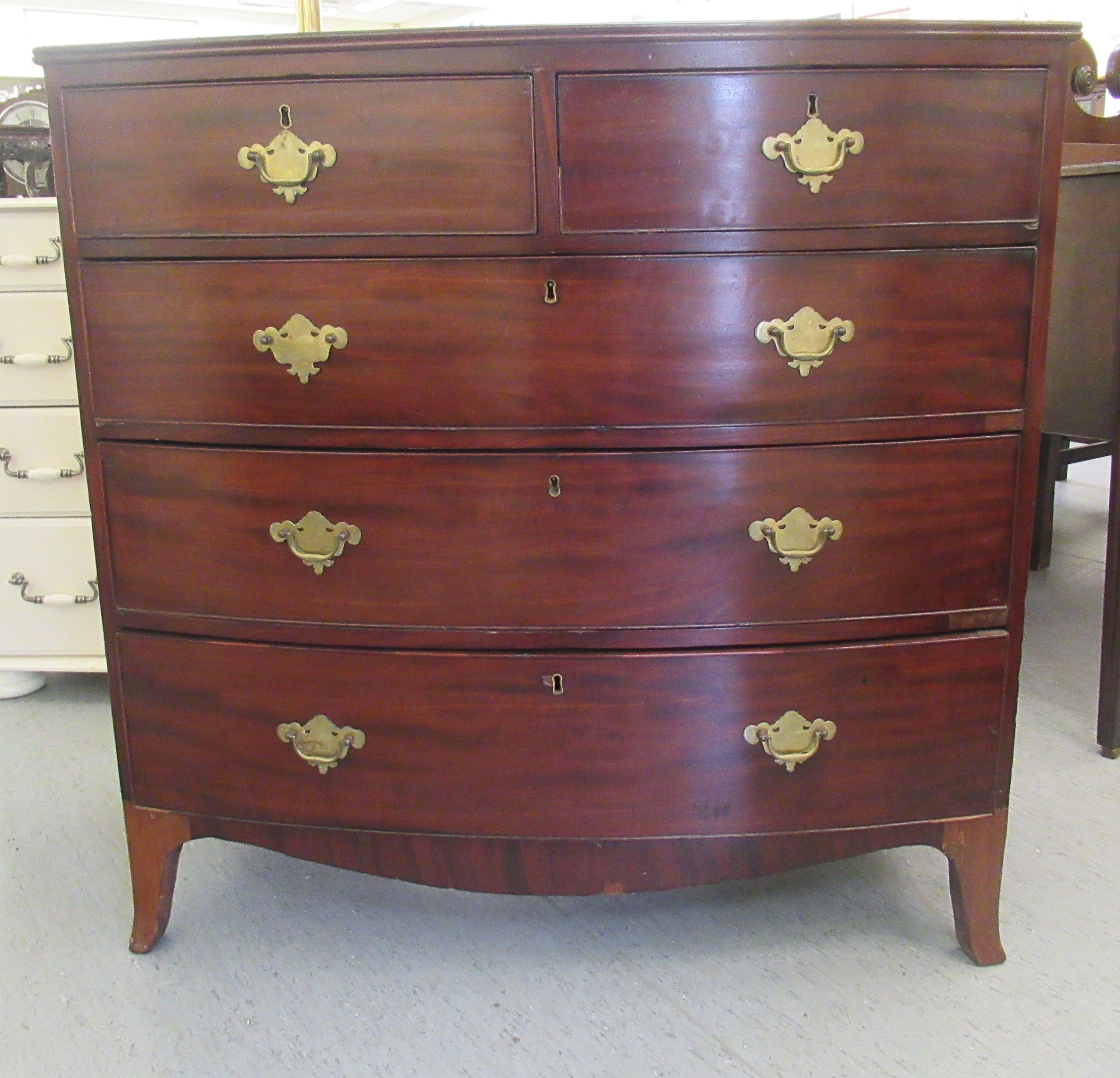 An early 19thC mahogany bow front dressing chest with two short/three graduated long drawers, on