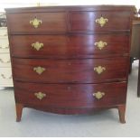 An early 19thC mahogany bow front dressing chest with two short/three graduated long drawers, on