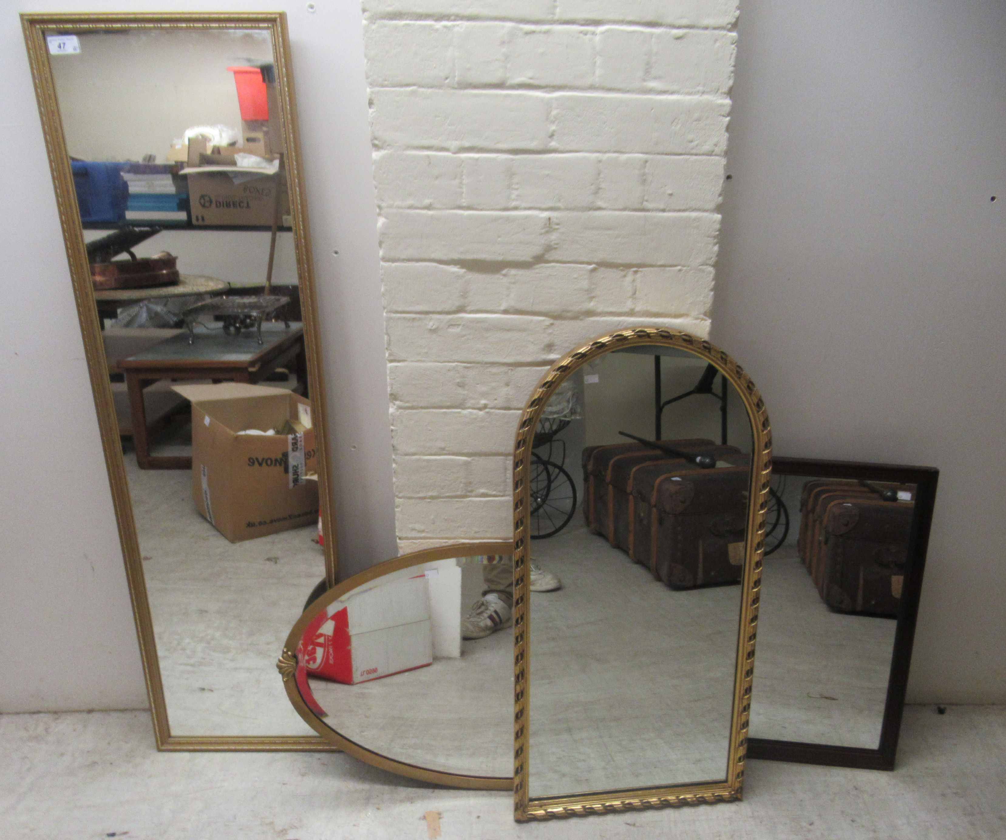 Four dissimilar modern framed mirrors  various forms  largest 47" x 13"