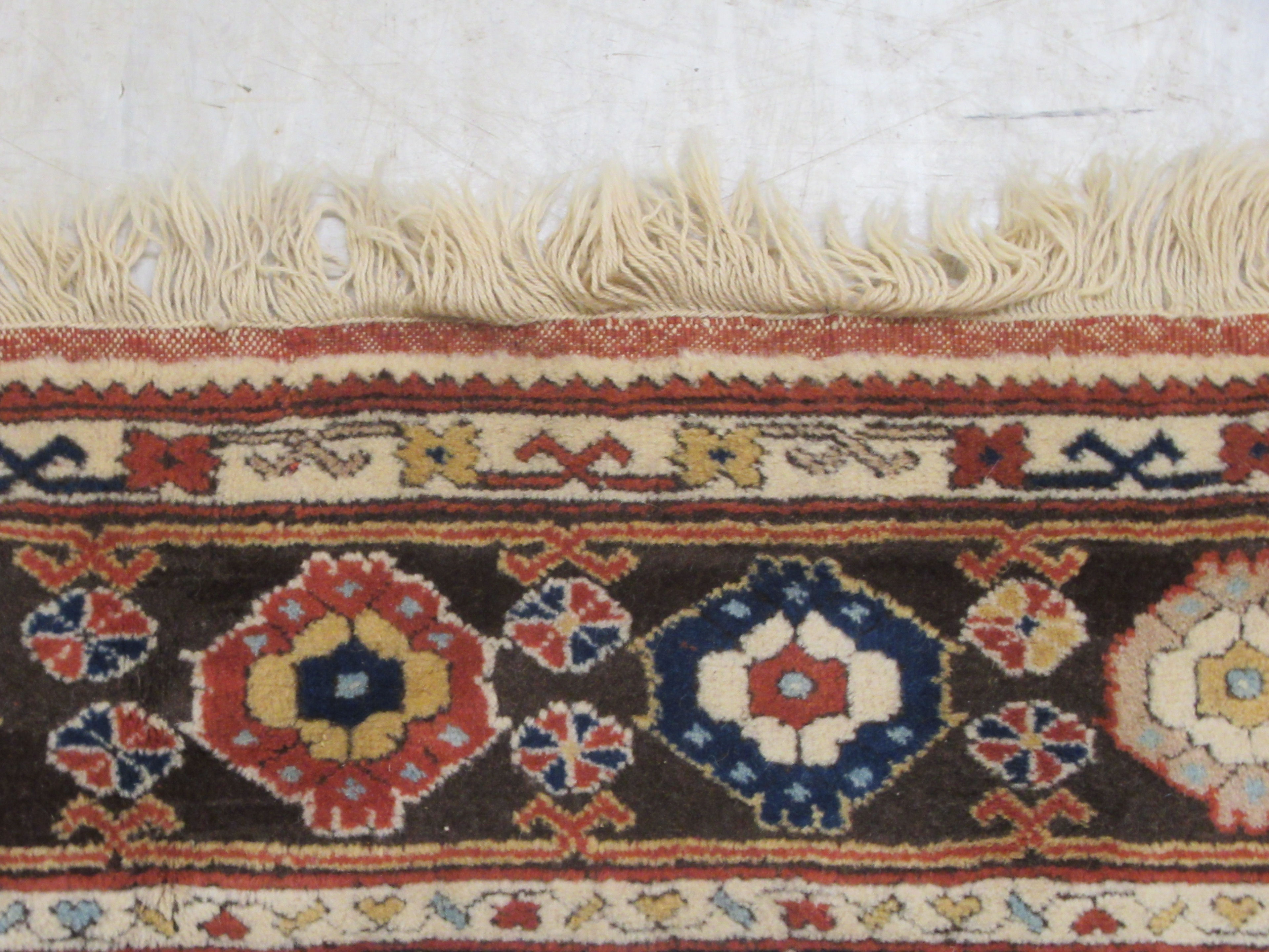 A Caucasian rug, decorated with repeating stylised designs, on a multi-coloured ground  58" x 88" - Image 4 of 5