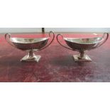 A pair of silver salts, fashioned as twin handled pedestal urns  Sheffield 1912
