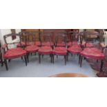 A set of twelve late 19thC walnut framed dining chairs with button red hide upholstery, raised on