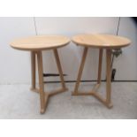 A pair of modern Ethnicraft light oak occasional tables, raised on square legs, united by a Y-shaped