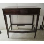 A mid 20thC mahogany freestanding, bow front (empty) canteen table, the rising top enclosing a