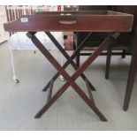 A late Victorian mahogany butlers tray, on a folding stand  32"h  30"w