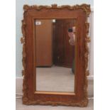 An early 20thC mirror, the plate set in a light oak and applied moulded gilt frame  19" x 31"