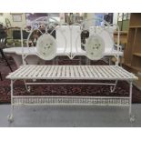 A mid 20thC white painted, wrought iron garden bench with a high back and faux woven seat, raised on