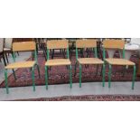 A set of four mid 20thC stacking schoolroom chairs with riveted plywood backs and seats, raised on