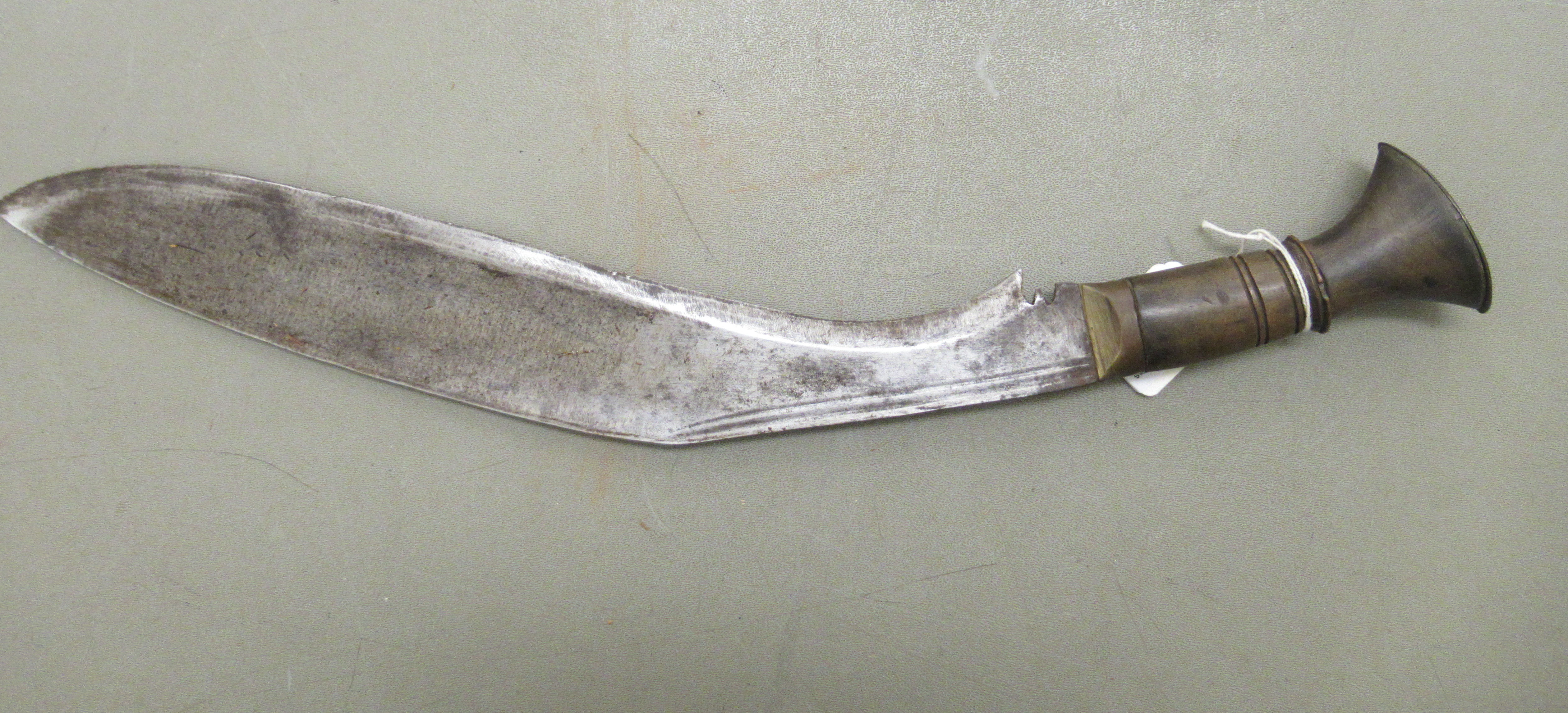 A 20thC Nepalese kukri on a, probably, horn handle  the blade 13"L, in a stitched hide sheath - Image 3 of 7