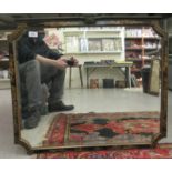 A 1920s mirror, the bevelled plate set in a black lacquered chinoiserie frame with re-entrant