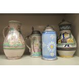 Three early 20thC Dutch earthenware tankards, decorated with various scenes with pewter lids  8-10"