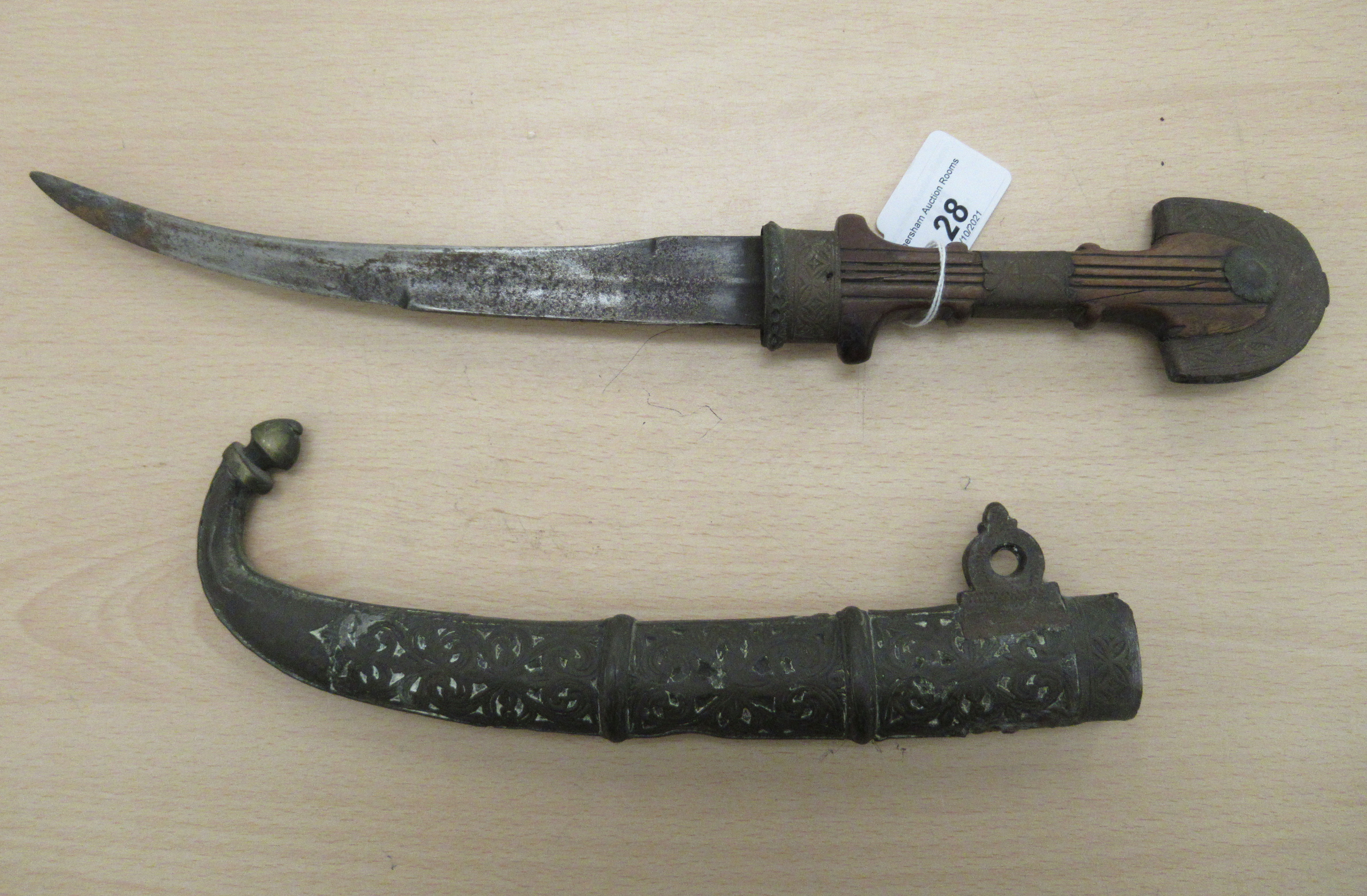 A 20thC Moroccan Koummya dagger, on a metal mounted fruitwood handle  the blade 9"L, in a cast metal - Image 2 of 2