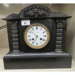 A late Victorian black slate cased mantel clock with lacquered cast bronze mounts, on a plinth;