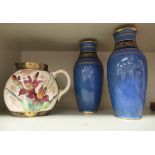 A pair of Royal Doulton sponged blue glazed and gilded baluster shaped vases with flared rims,