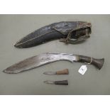 A 20thC Nepalese kukri on a, probably, horn handle  the blade 13"L, in a stitched hide sheath