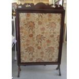 An Edwardian mahogany firescreen, set with a tapestry panel, raised on splayed legs  43"h  28"w