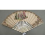 A 19thC fan with carved and inked bone sticks, the folding paper leaf painted on both sides with