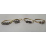 Four variously set 9ct gold metal rings: to include a single stone diamond example