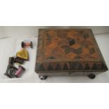 A Regency parquetry and marquetry sewing box of casket form with a hinged lid, enclosing a paper