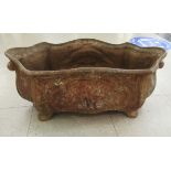 An early 20thC Pecharaud, France, decoratively cast iron planter of oval, serpentine outline,