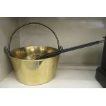 A late 19thC cast brass preserve pan with a wrought iron swing handle  12"dia; and a pair of