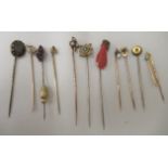 A selection of antique stickpins: to include an enamelled mourning example, set with a lock of hair;