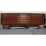 A mid 20thC Danish Skovby rosewood finished sideboard with five central drawers, flanked by two