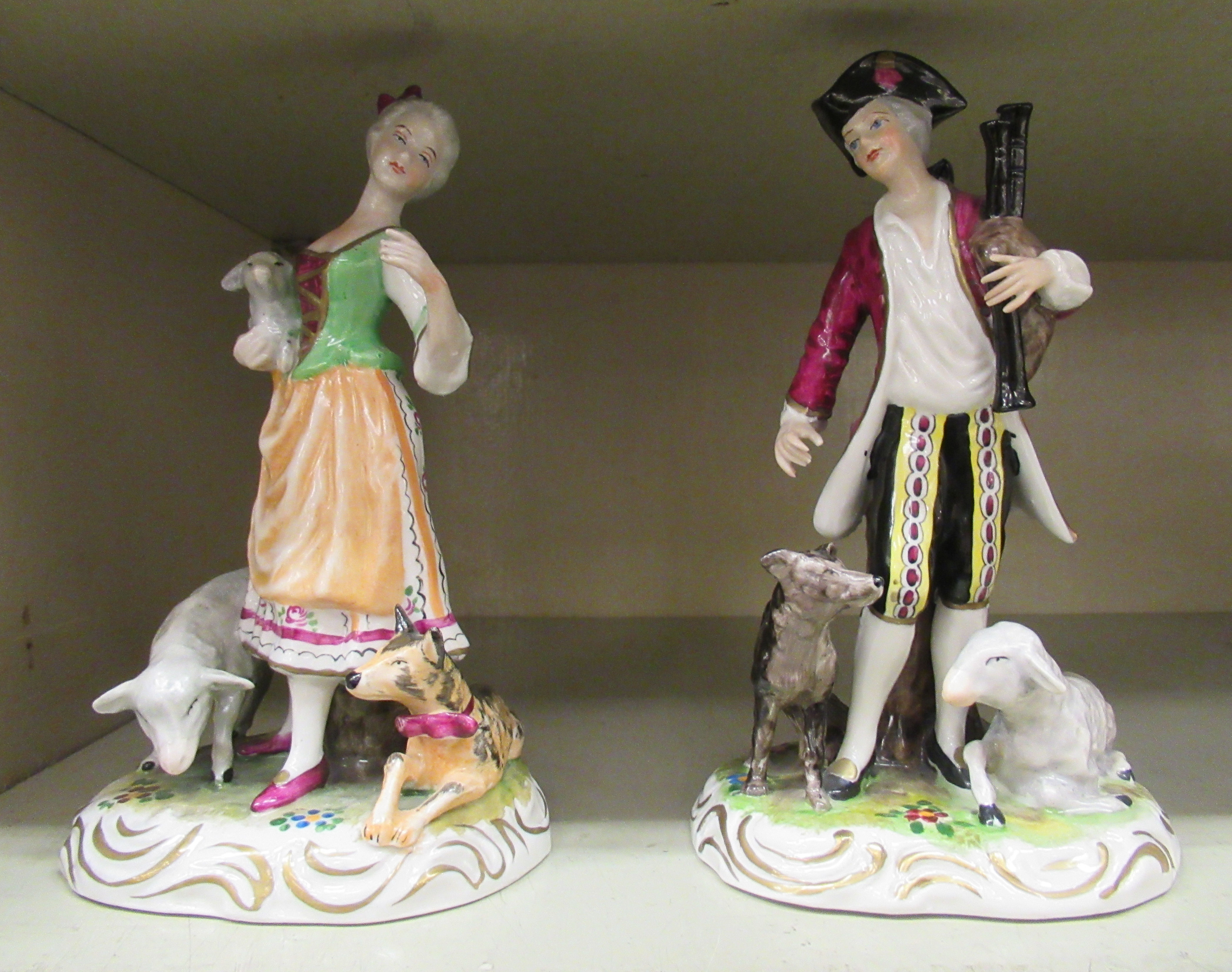 A pair of 20thC Wilhelm Rittirsch porcelain figures, viz. a young woman with a lamb, a sheep and a