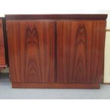 A mid 20thC Danish Skovby rosewood finished cabinet with two doors, on a plinth  33"h  40"w