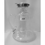 An Edwardian glass decanter fashioned as a whisky tot with a star cut base, applied silver collar