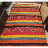 An African rug, decorated in bright colours  48" x 96"