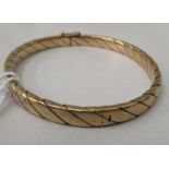 A 9ct gold hinged bangle