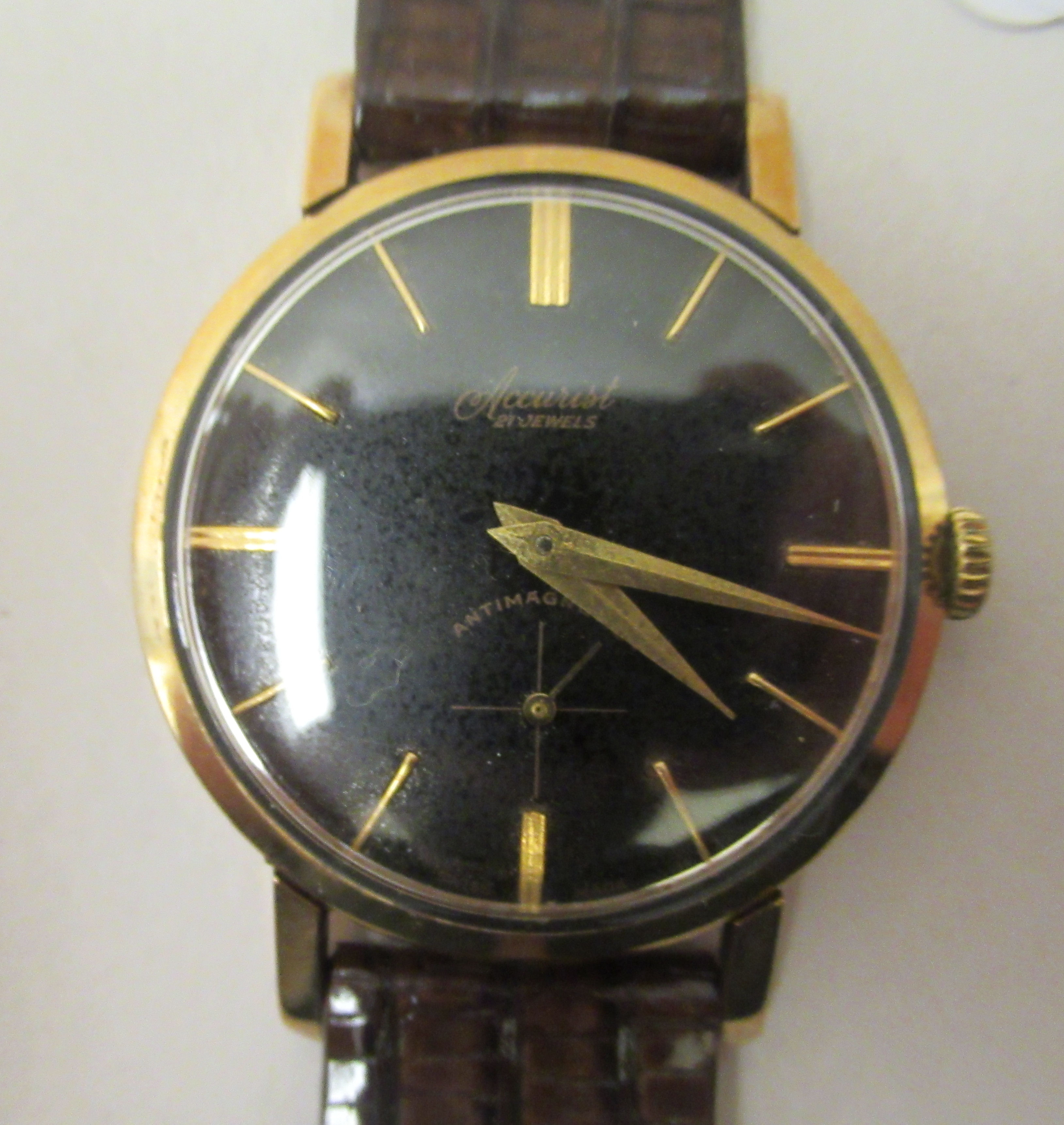 A 1960s Accurst 9ct gold cased wristwatch, faced by a black baton dial, incorporating subsidiary