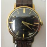 A 1960s Accurst 9ct gold cased wristwatch, faced by a black baton dial, incorporating subsidiary