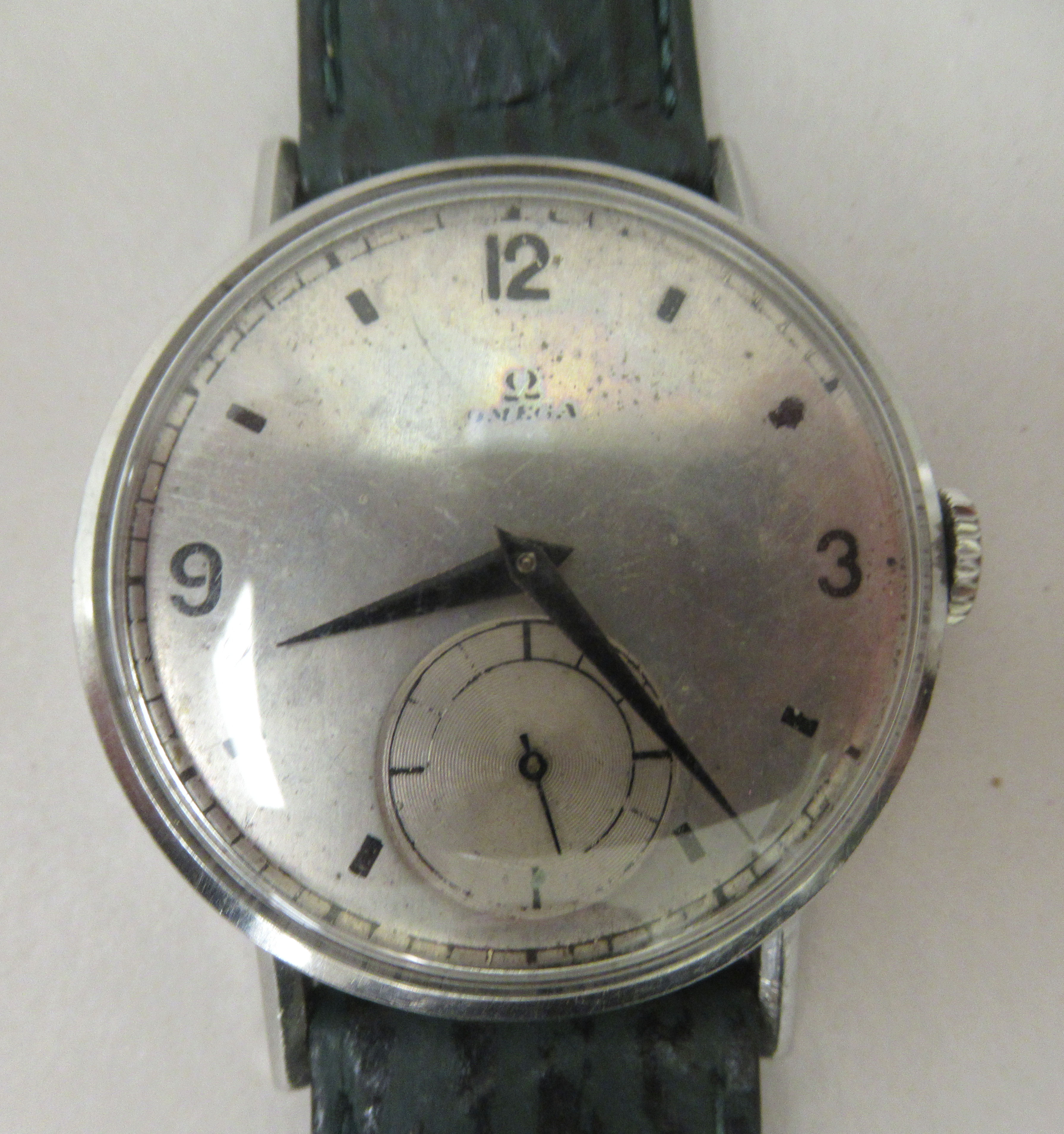 A 1940s Omega stainless steel cased wristwatch, faced by an Arabic and baton dial, incorporating