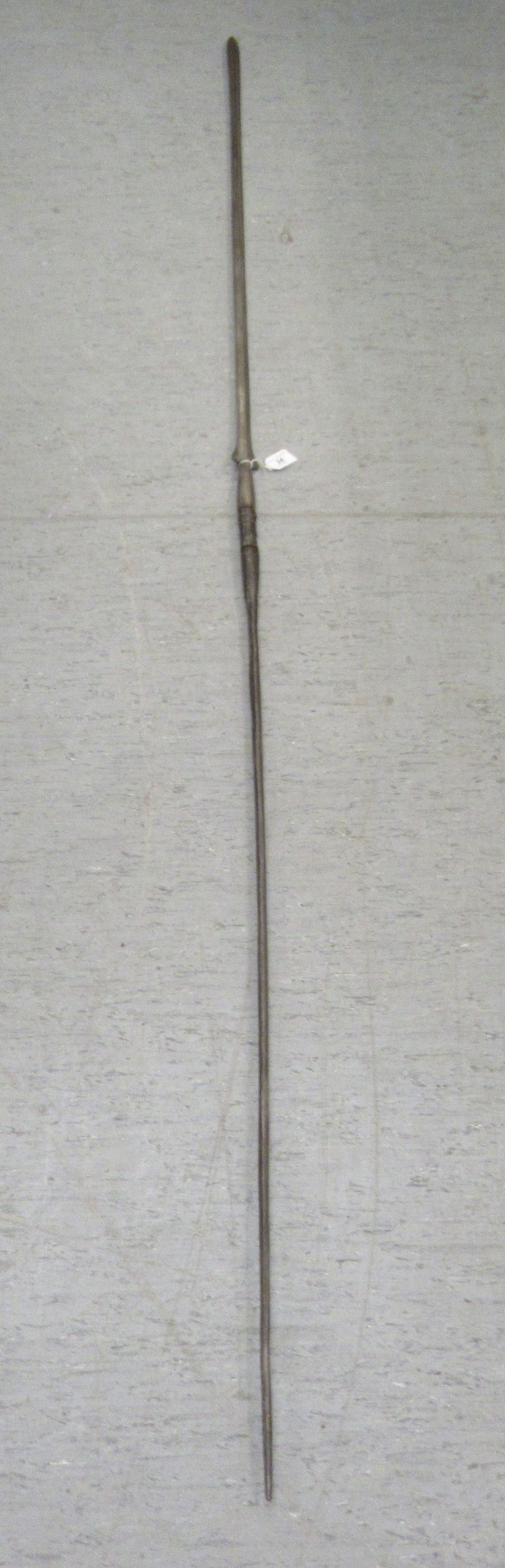 A 20thC African double end spear, the shaft wrapped with a spiral metal ringlet  92'L