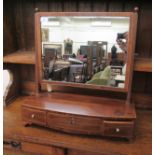 A 19thC boxwood string inlaid mahogany framed toilet mirror, the plate pivoting on angled horns