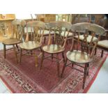 Two matched pairs of 19thC beech and elm framed Windsor kitchen chairs, each having a curved bar