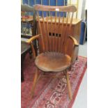 An early 20thC Arts & Crafts inspired beech framed high, spindled comb back, open arm chair, the