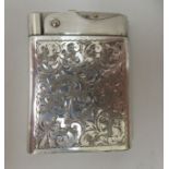 A Wifeu Austrian silver coloured metal cased cigarette lighter with foliate scroll engraved ornament