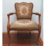 A 20thC French beech framed open arm salon chair, the floral tapestry upholstered back and seat