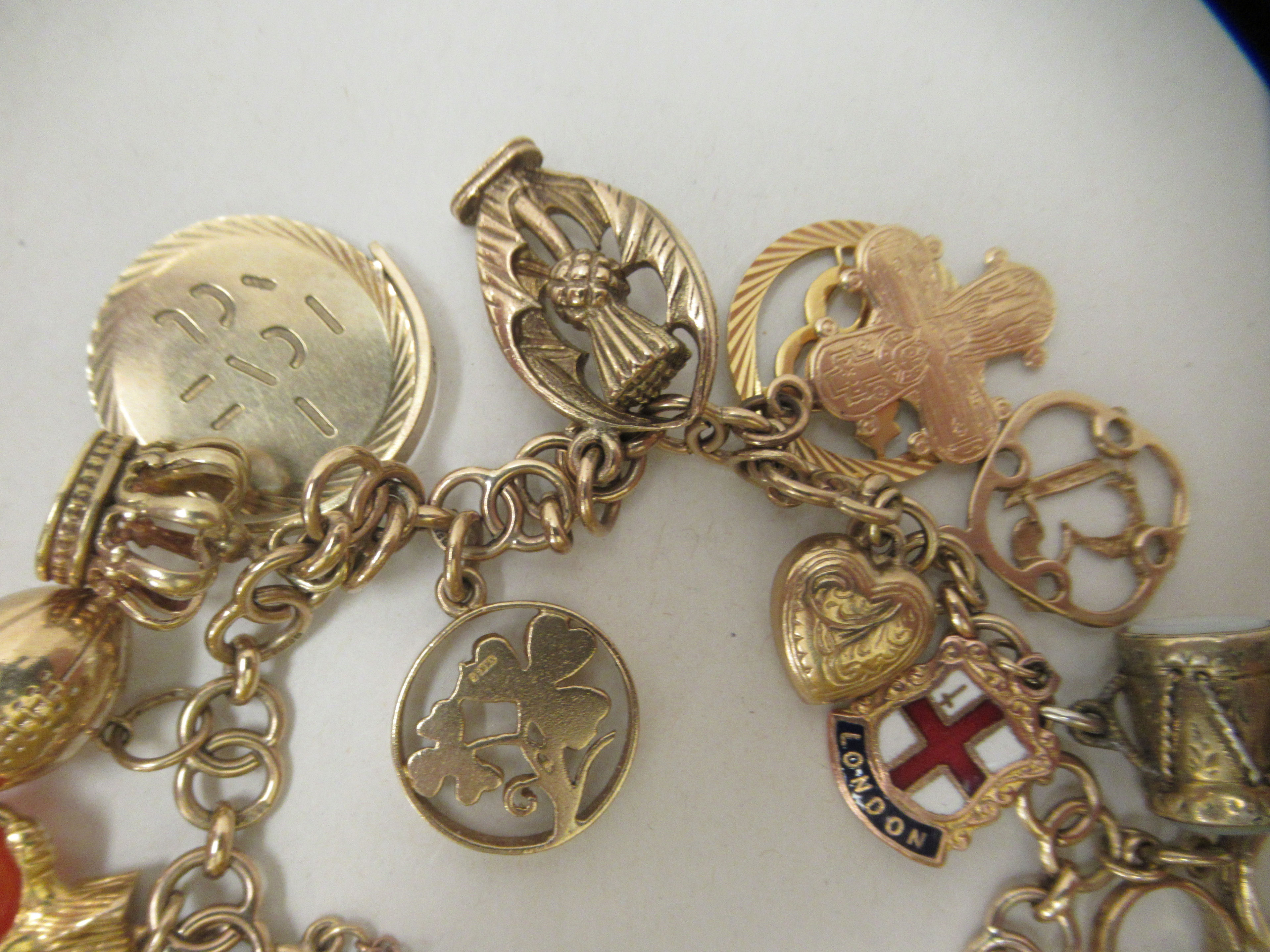 A 9ct gold and yellow metal charm bracelet with various charms - Image 5 of 5