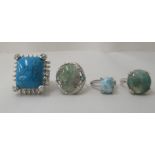 Four silver coloured metal dress rings, variously set with green and blue stones